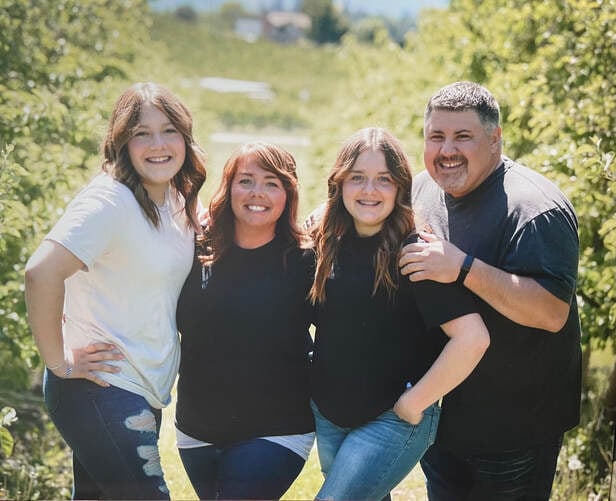 Brad and Diana Shardlow with their daughters Norelle and Gillian, outdoors in spring